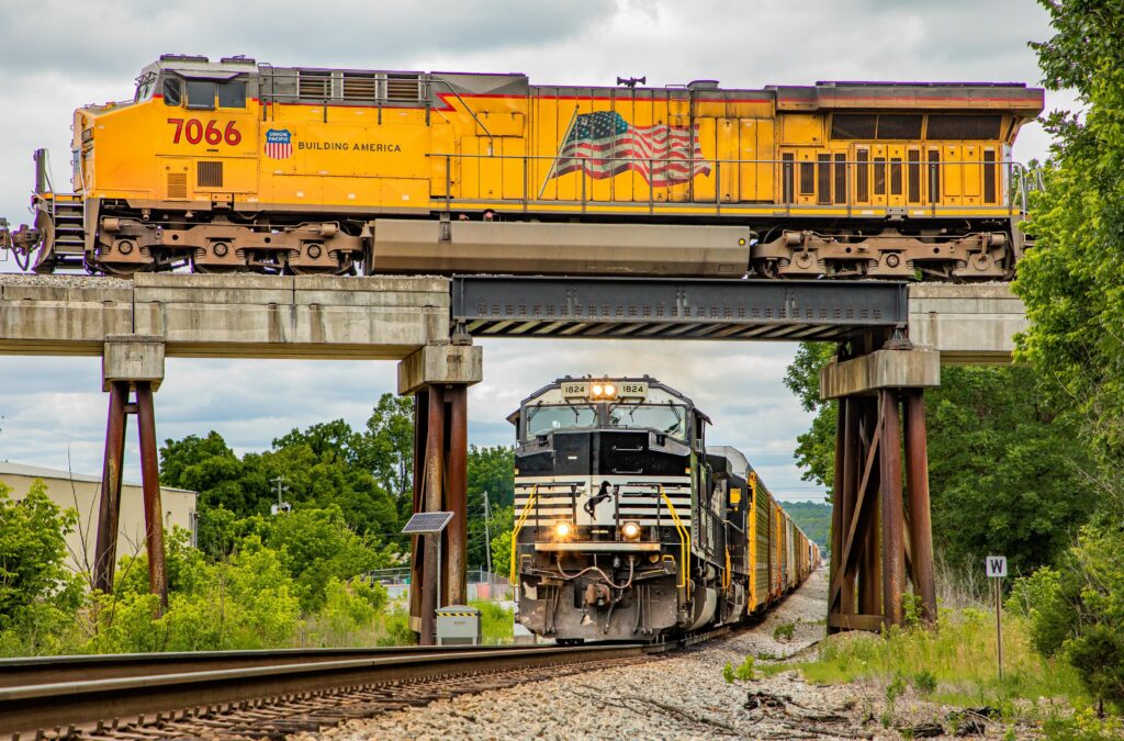 Union Pacific locomotive 7066 crosses a bridge above Norfolk Southern locomotive 1824 in Leeds, Alabama.