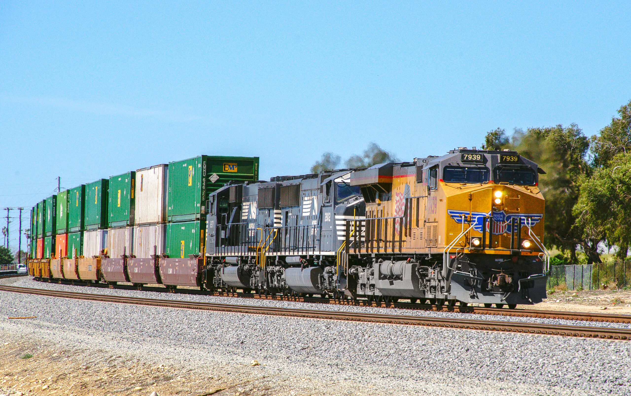 Union Pacific locomotive leading a freight train with Norfolk Southern locomotives and intermodal containers