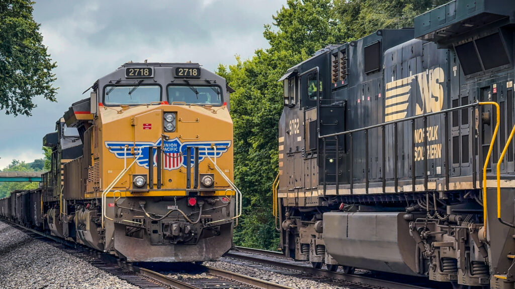 Union Pacific and Norfolk Southern locomotives on parallel tracks