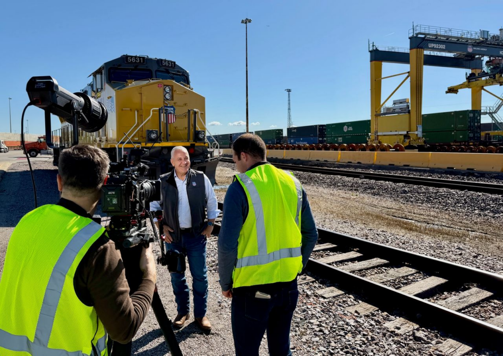 Jim Vena being interviewed at a Union Pacific intermodal rail yard.