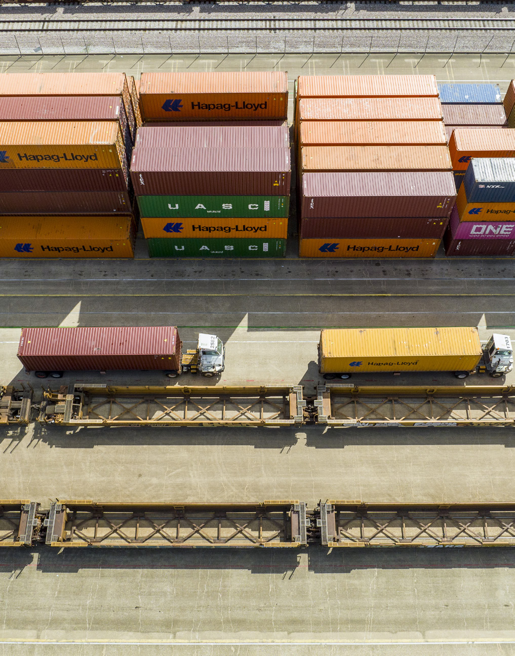Intermodal containers and rail equipment at a freight terminal.